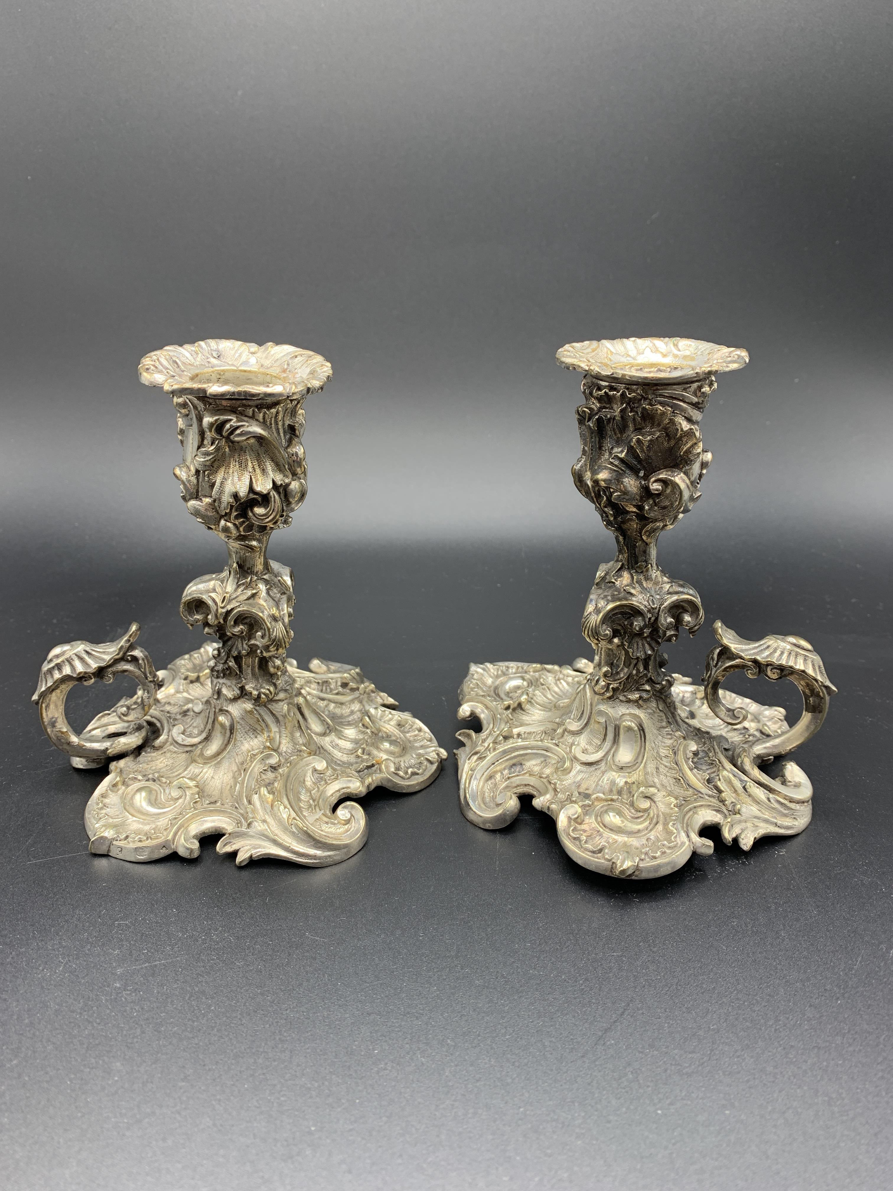 A pair of mid-19th century rococo silver plate candle holders by Elkington & Co