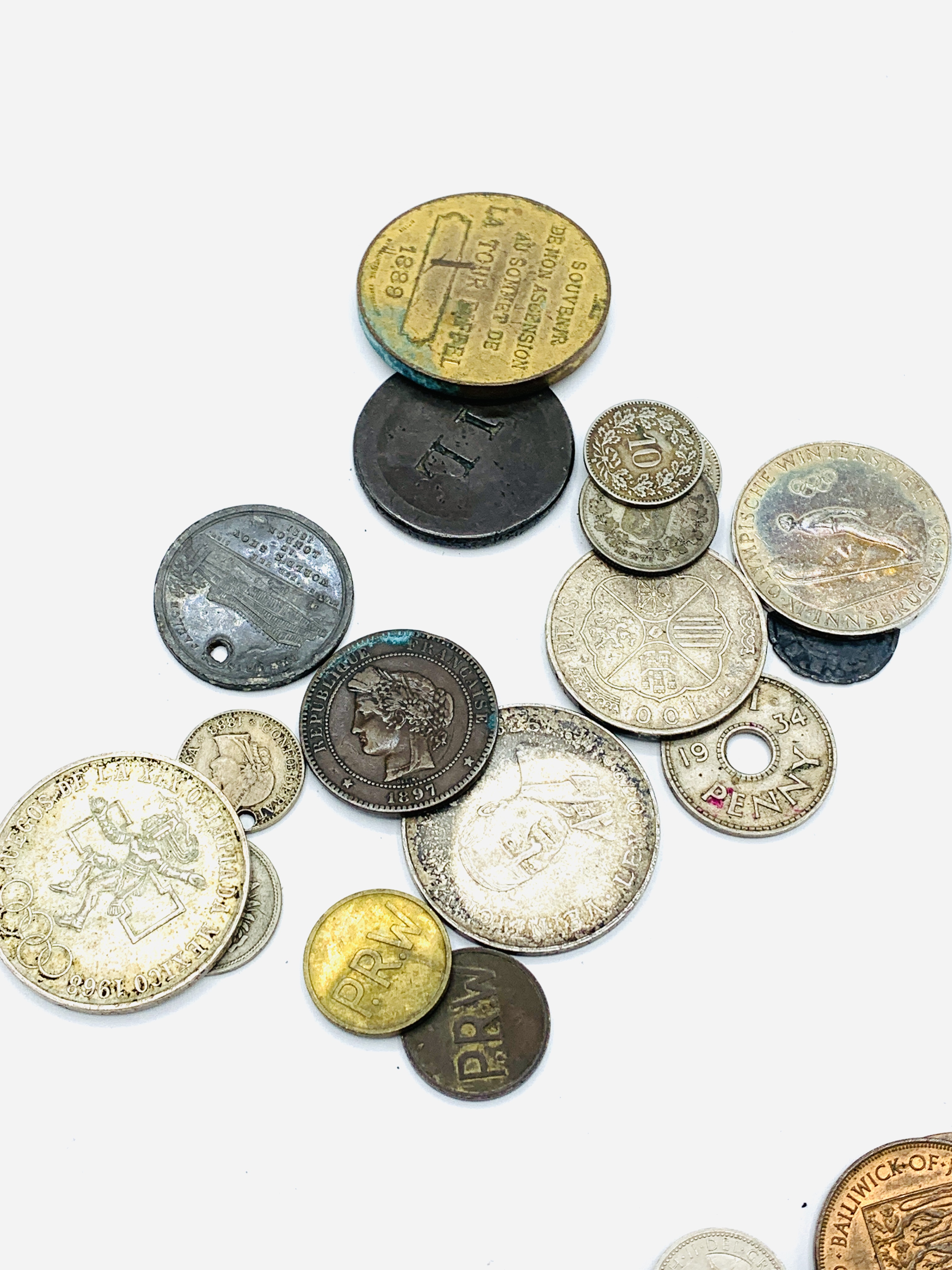 A collection of foreign coins and tokens together with some GB tokens and coins