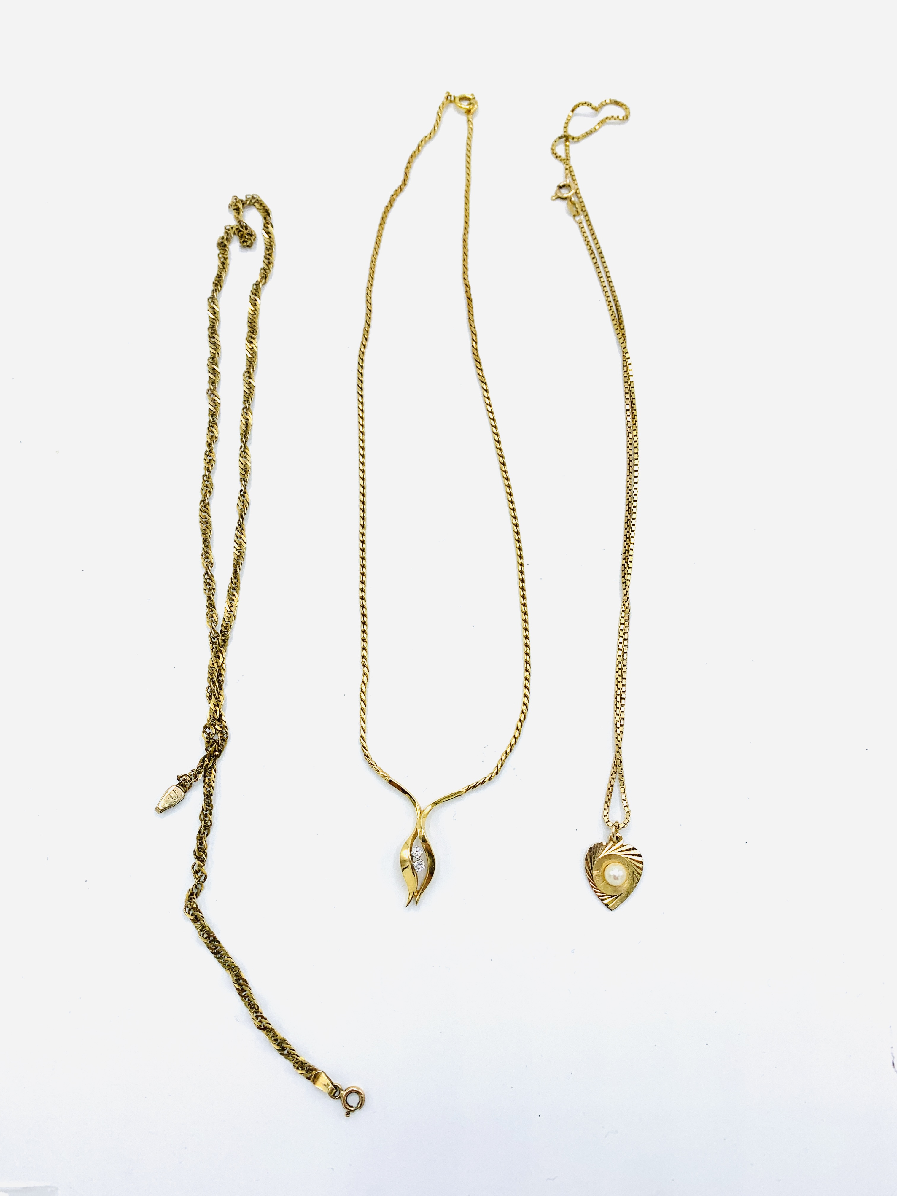A 9ct gold pendant together with a 9ct gold necklace and a 9ct gold chain