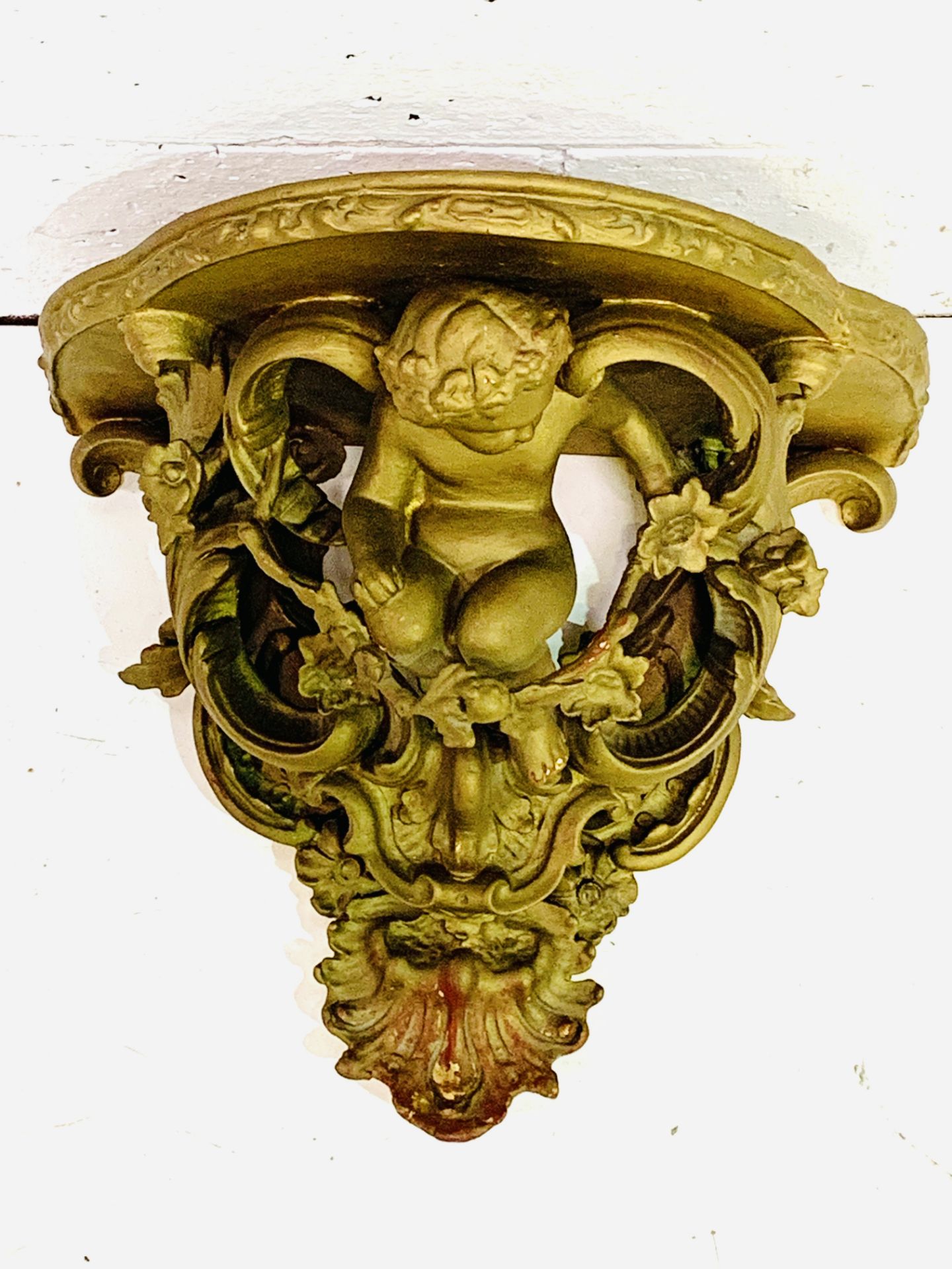 Carved gilded cherubic wall bracket