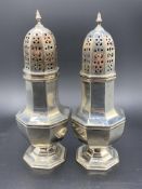 A pair of hallmarked silver sugar casters