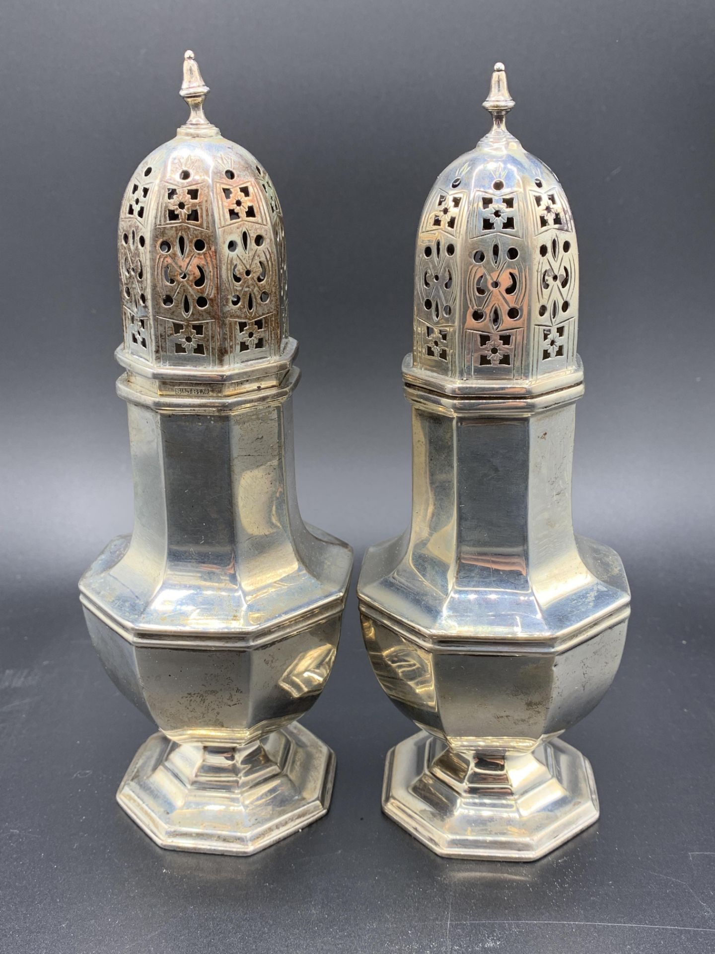 A pair of hallmarked silver sugar casters