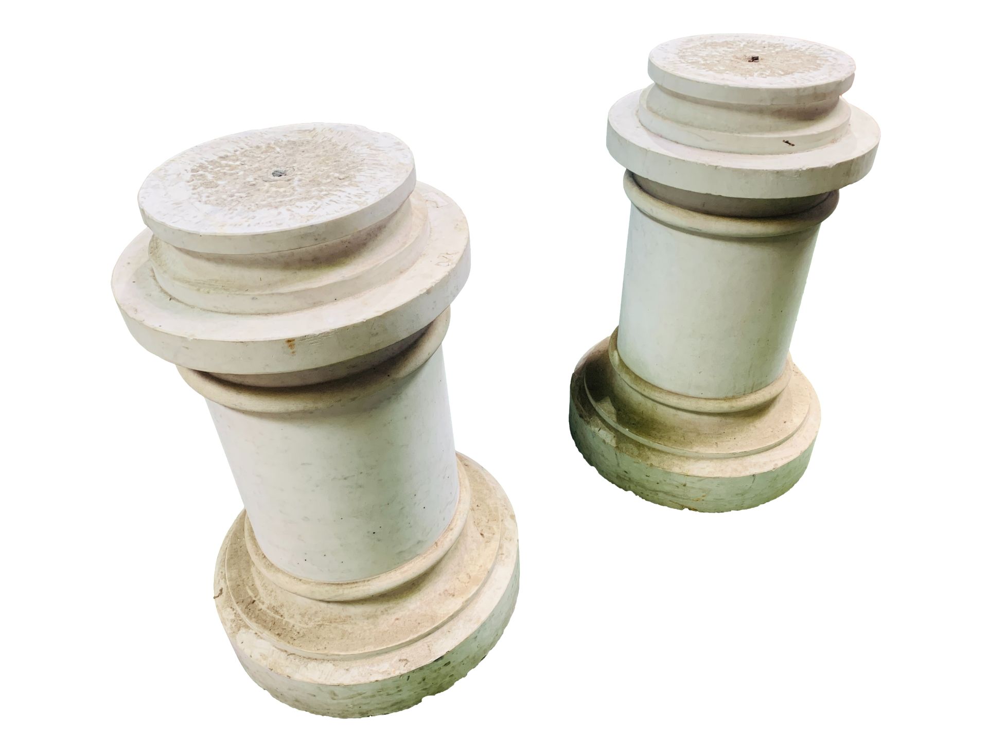 A pair of short crema marfil marble columns