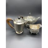 A silver teapot, a silver coffee pot and a Georgian silver cream jug