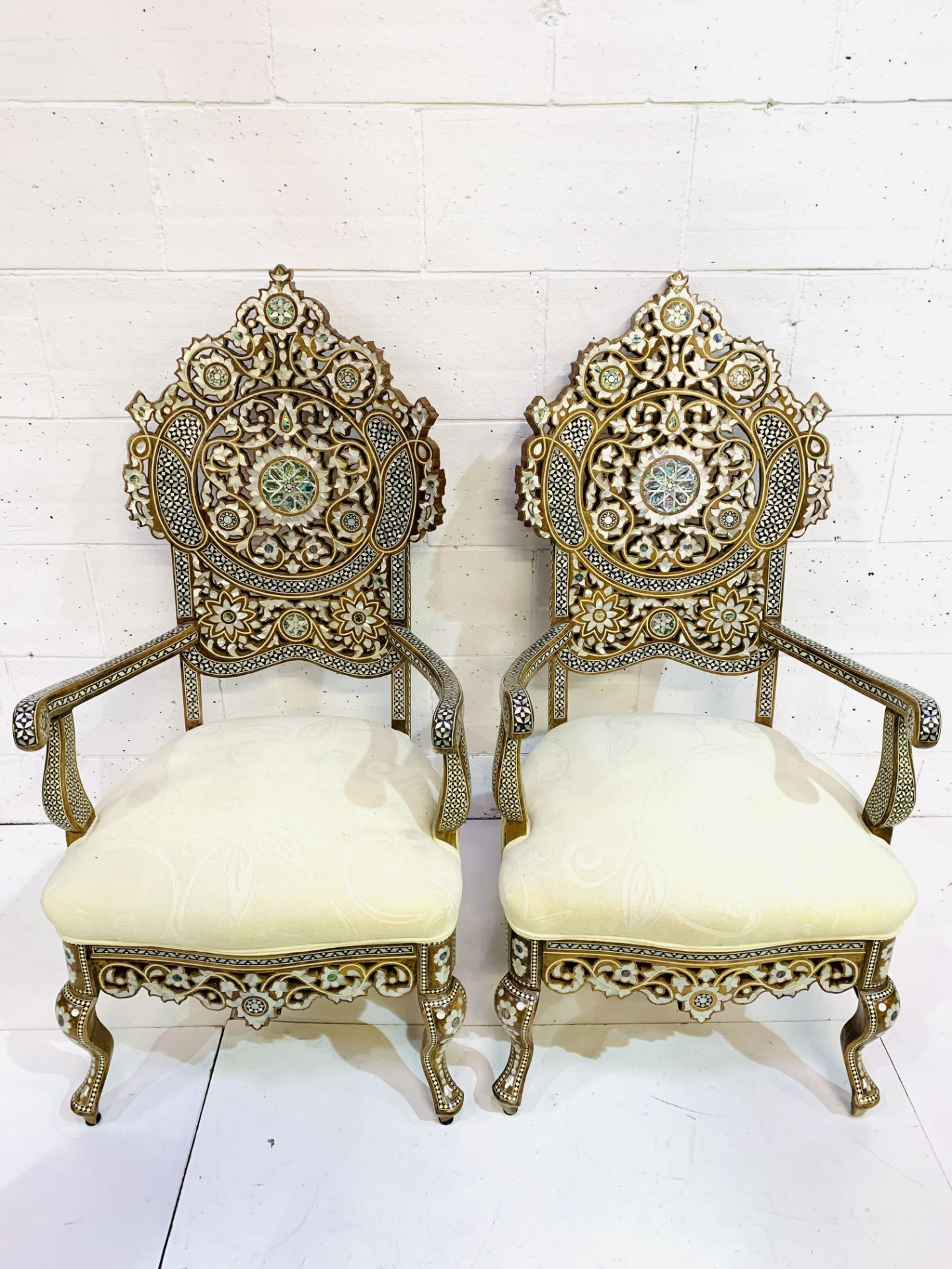 Pair of open armchairs profusely decorated with mother of pearl