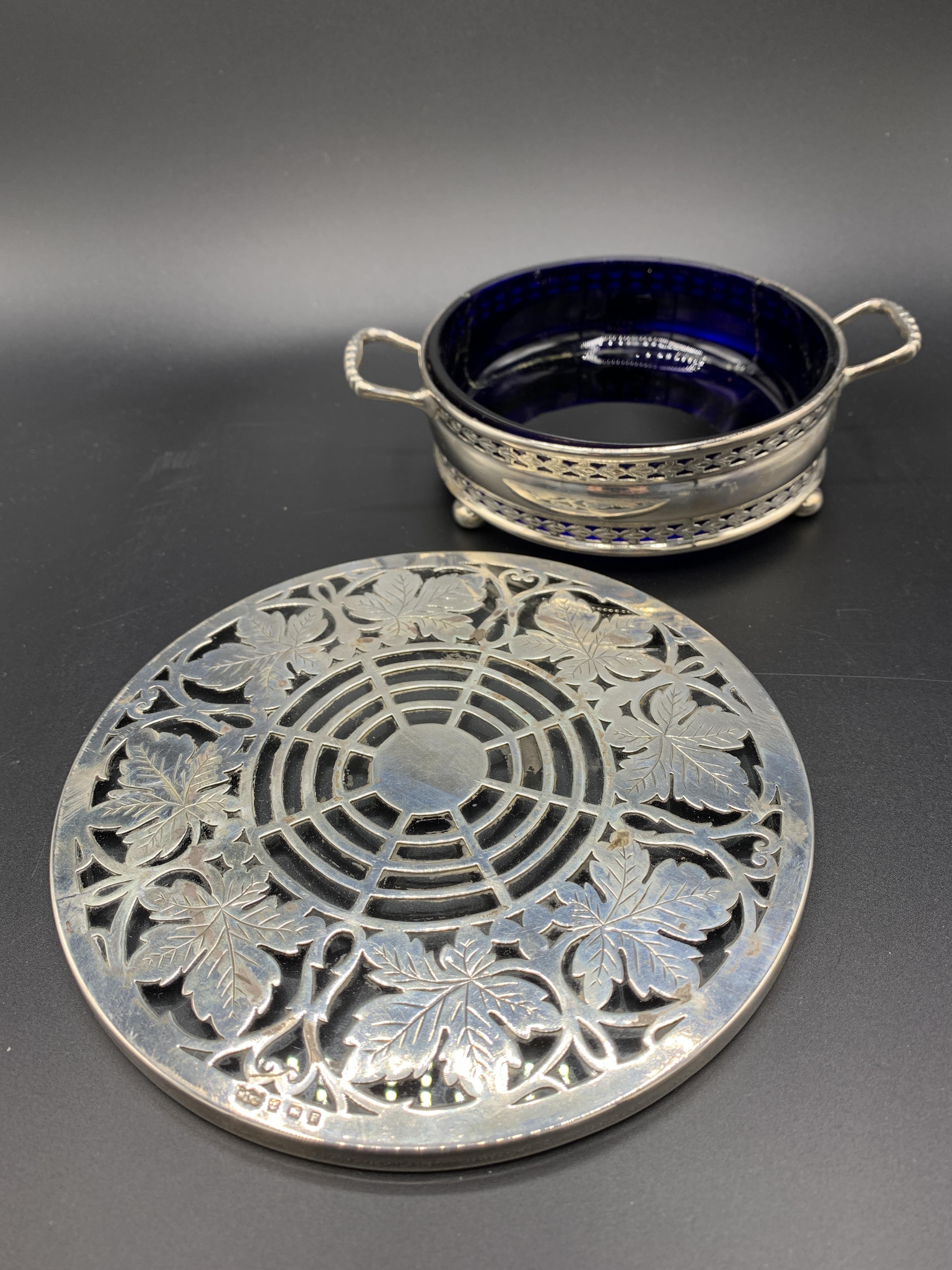 A silver mounted circular glass stand by Mappin & Webb and a silver two handled three footed dish