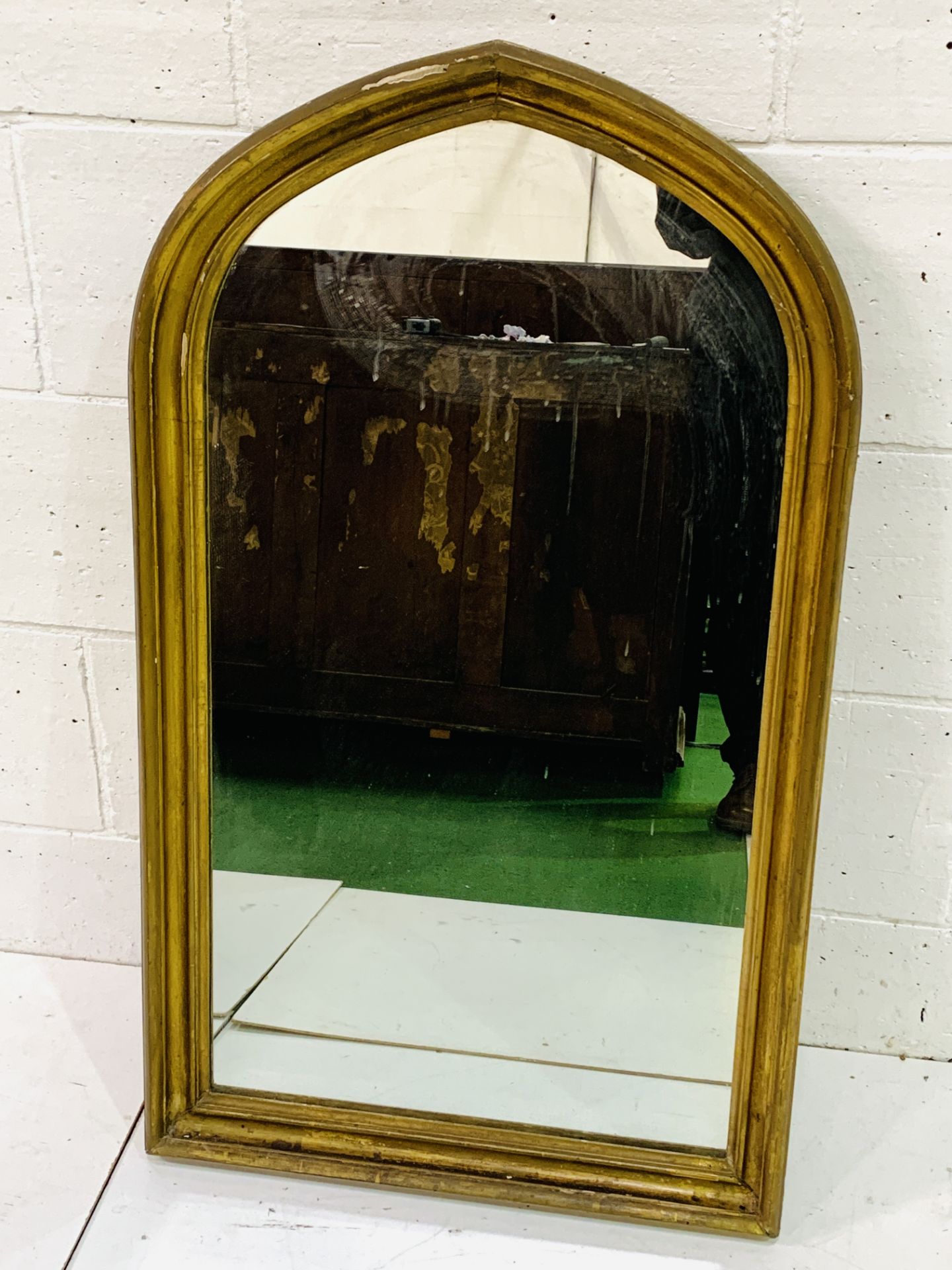 Gilt wood framed lancet shaped wall mirror