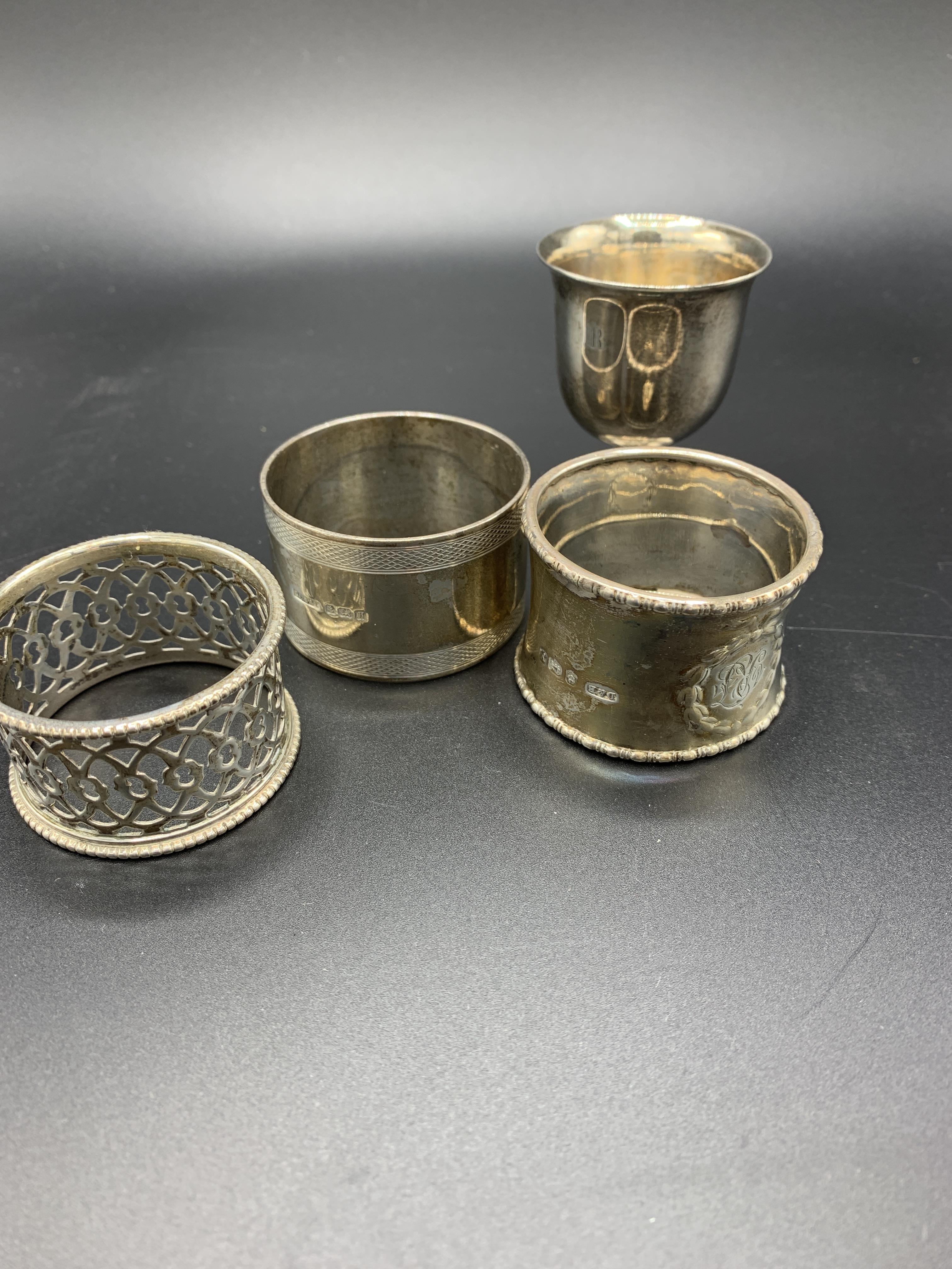 A hallmarked silver and gilt drinks measure, a silver egg cup, and three silver napkin rings - Image 2 of 4