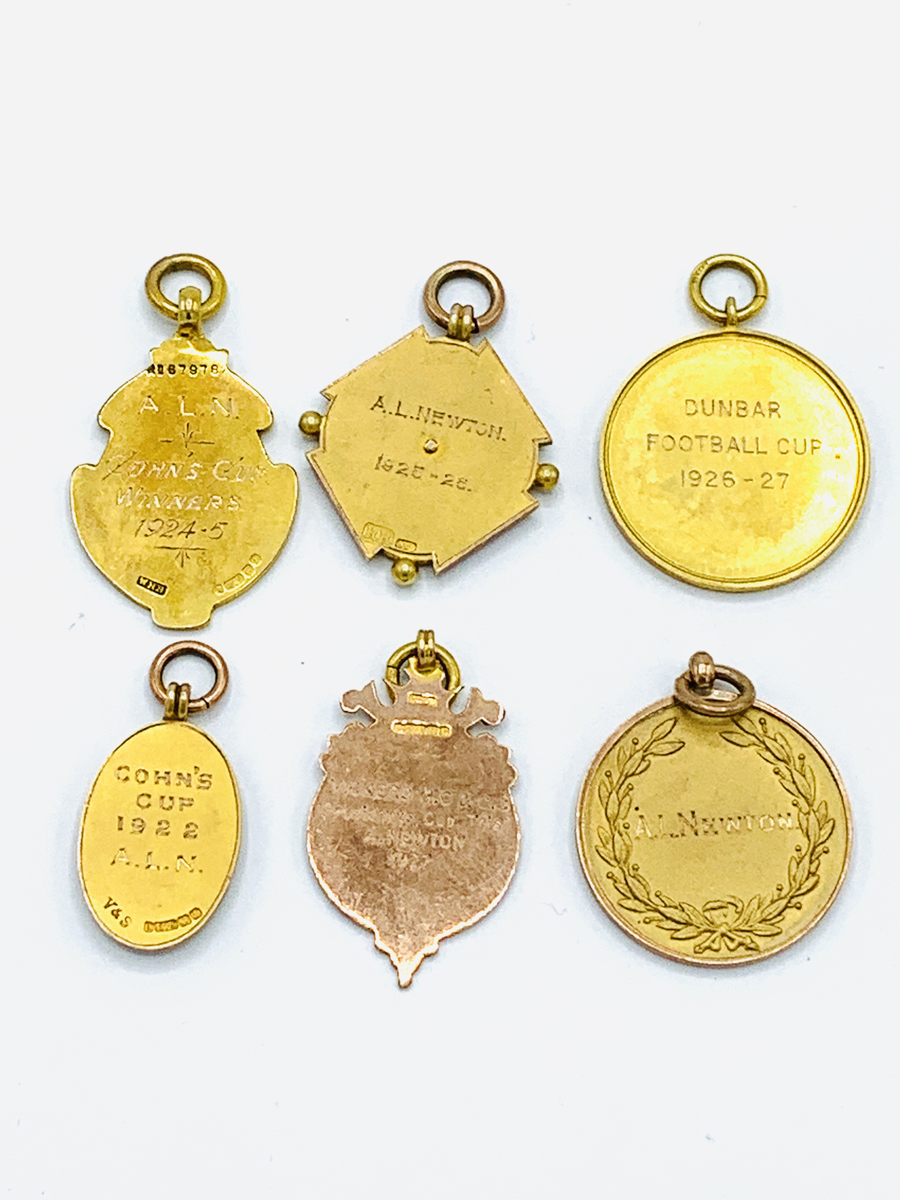 Five 9ct gold football medals plus another - Image 4 of 4