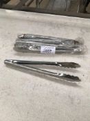 Four stainless steel tongs