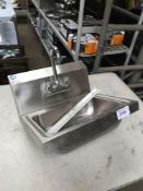 Stainless steel hand sink with tap.