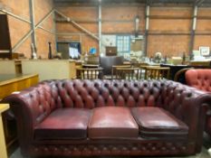 Red button back leather effect Chesterfield style three seat sofa