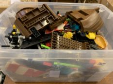 A box of Lego and similar building blocks, including gears