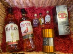 A wicker hamper containing a quantity of whiskies