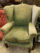 Green cord upholstered wing back armchair