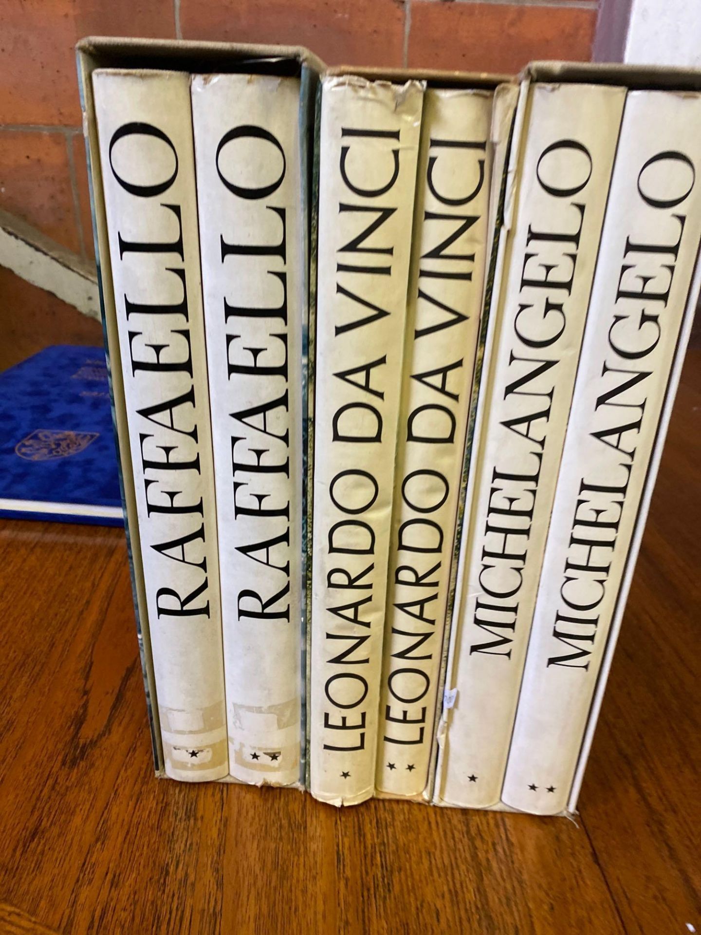 Three box sets of books on Raffaello, Leonardo da Vinci and Michelangelo
