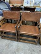 A pair of oak framed open armchairs upholstered in brown studded leather