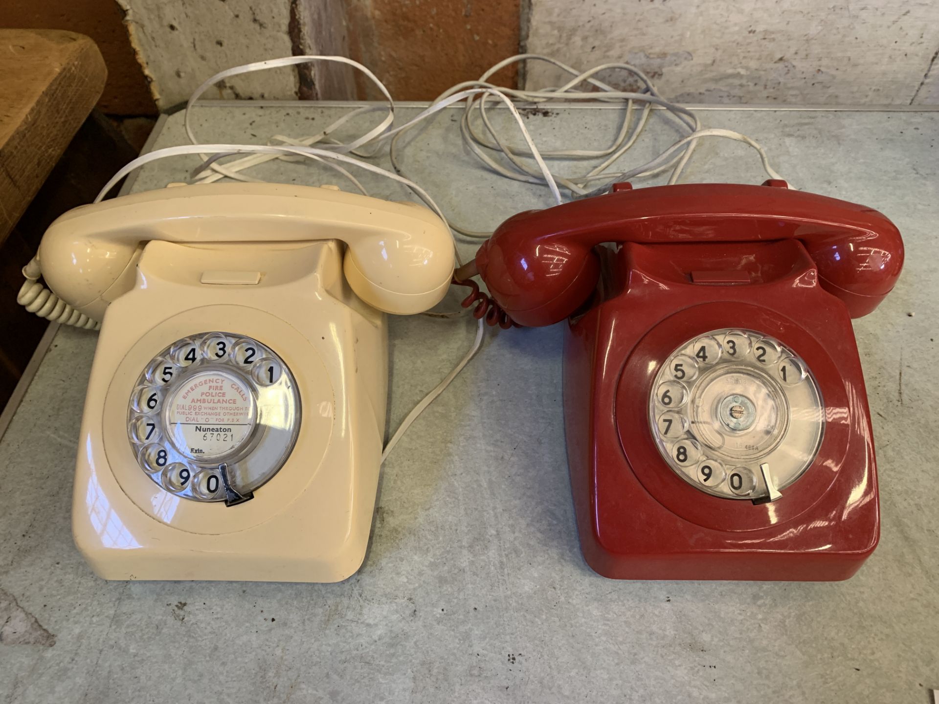 Tele 8746F red plastic telephone and a cream plastic one