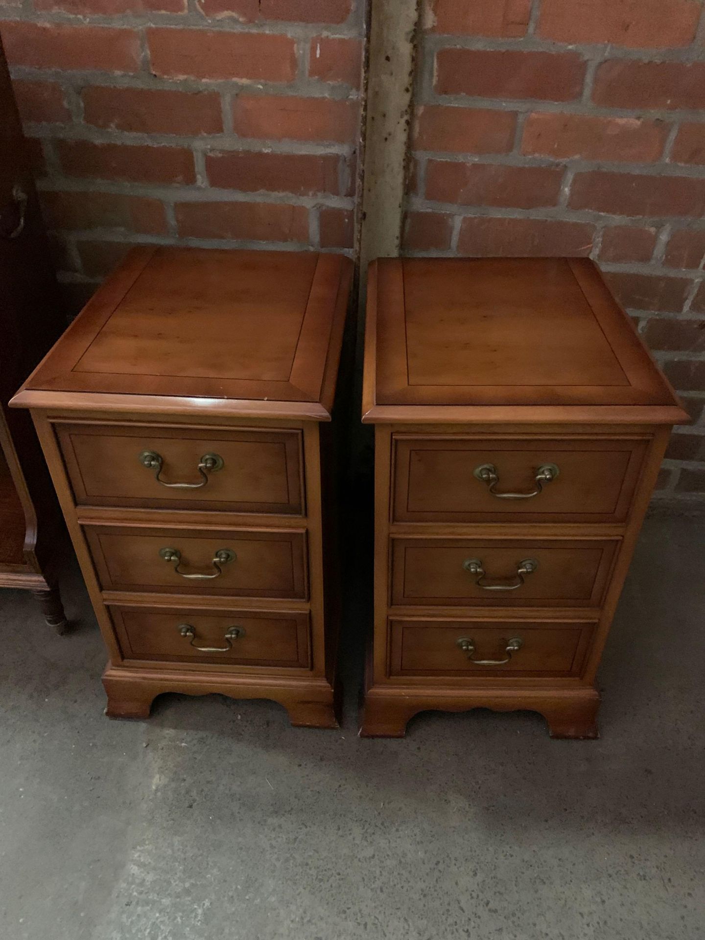 A pair of reproduction 3 drawer bedside cabinets