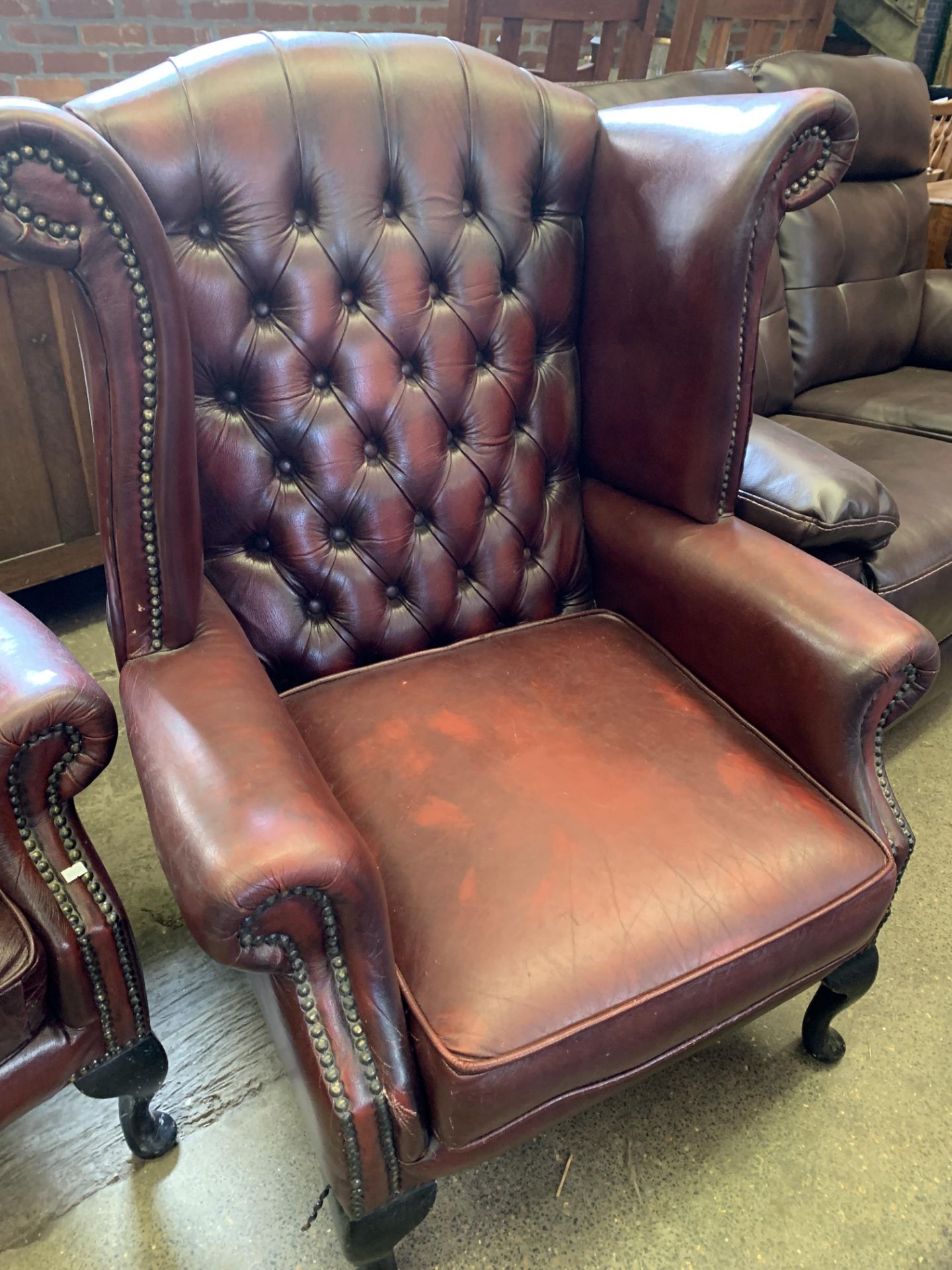 Red button leather-effect wing back armchair