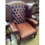 Red button leather-effect wing back armchair