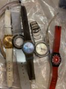 A collection of seven Swatch watches and other watches