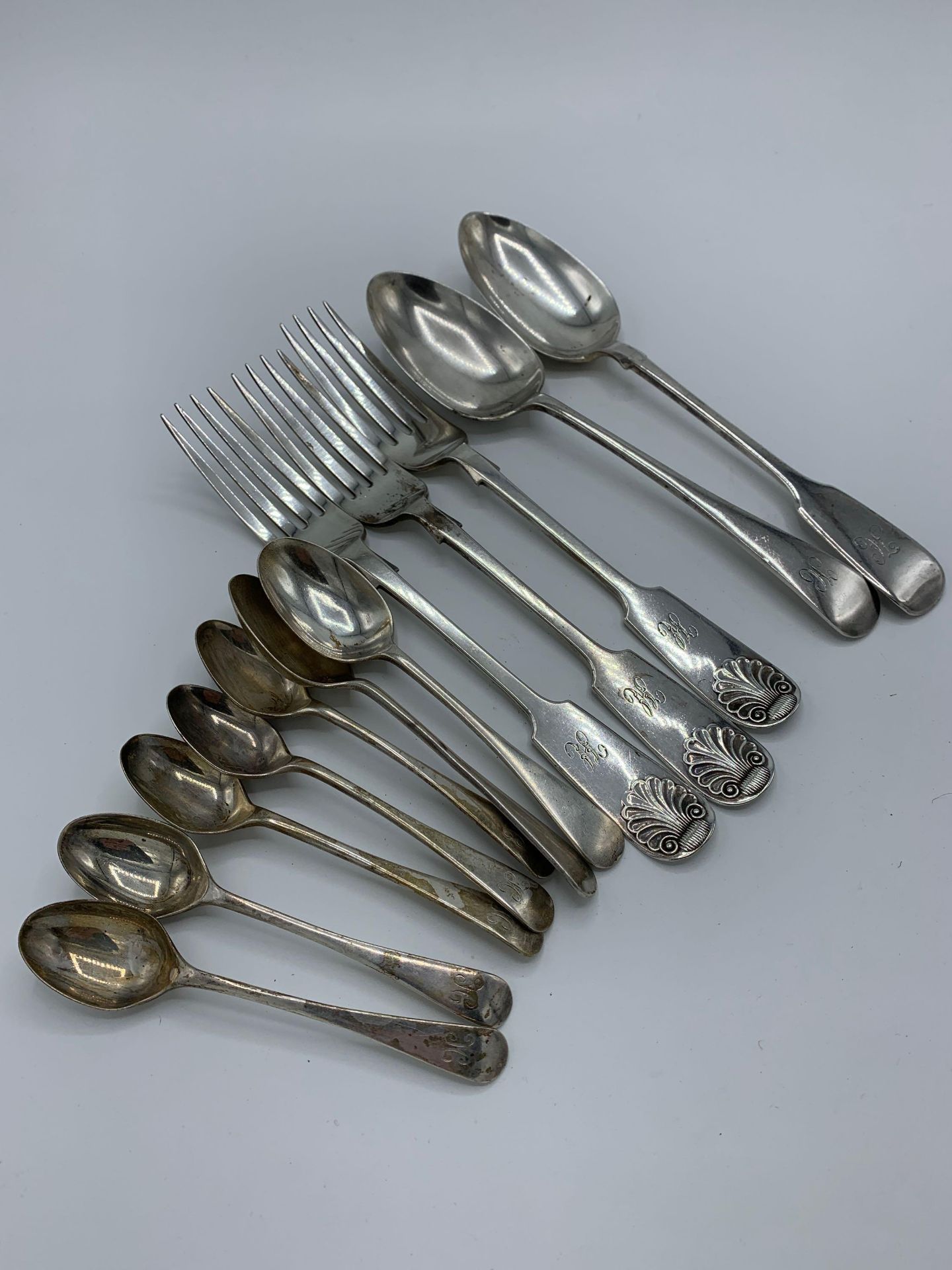 Two hallmarked silver table spoons and three table forks, and other silver cutlery