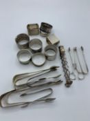 Hallmarked silver sugar tongs and napkin rings