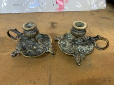 A pair of French 19th century ornate cast brass chambersticks