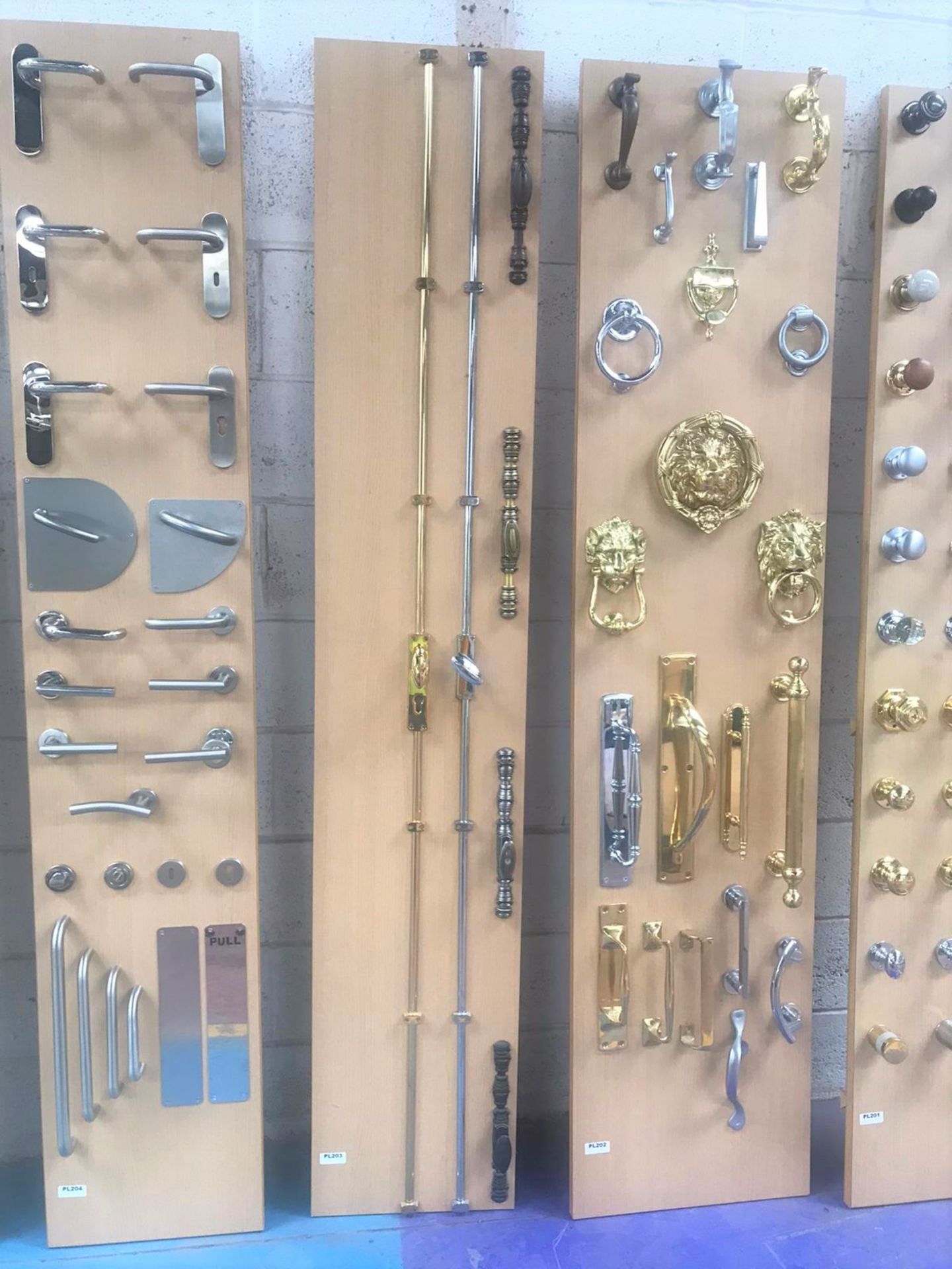 Large Collection of Display Units Fitted With Various Door Handles, Knobs, Knockers, Switches,