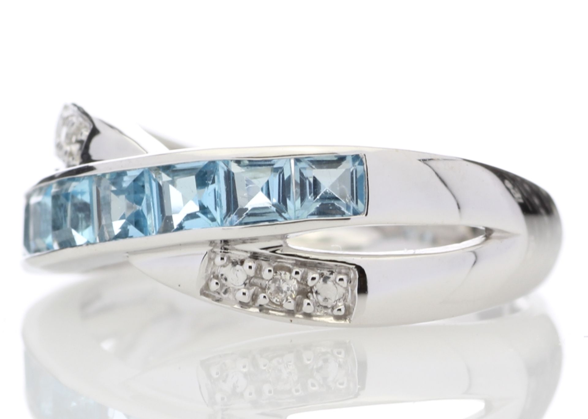 9ct White Gold Blue Topaz And Diamond Ring 0.06 Carats - Valued by GIE £1,625.00 - This twist on a - Image 2 of 9