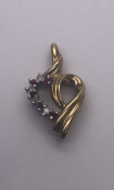 9 carat Yellow Gold Heart Pendant set with 4 Round Cut Diamonds and 5 Round Cut Rubies 1.3g