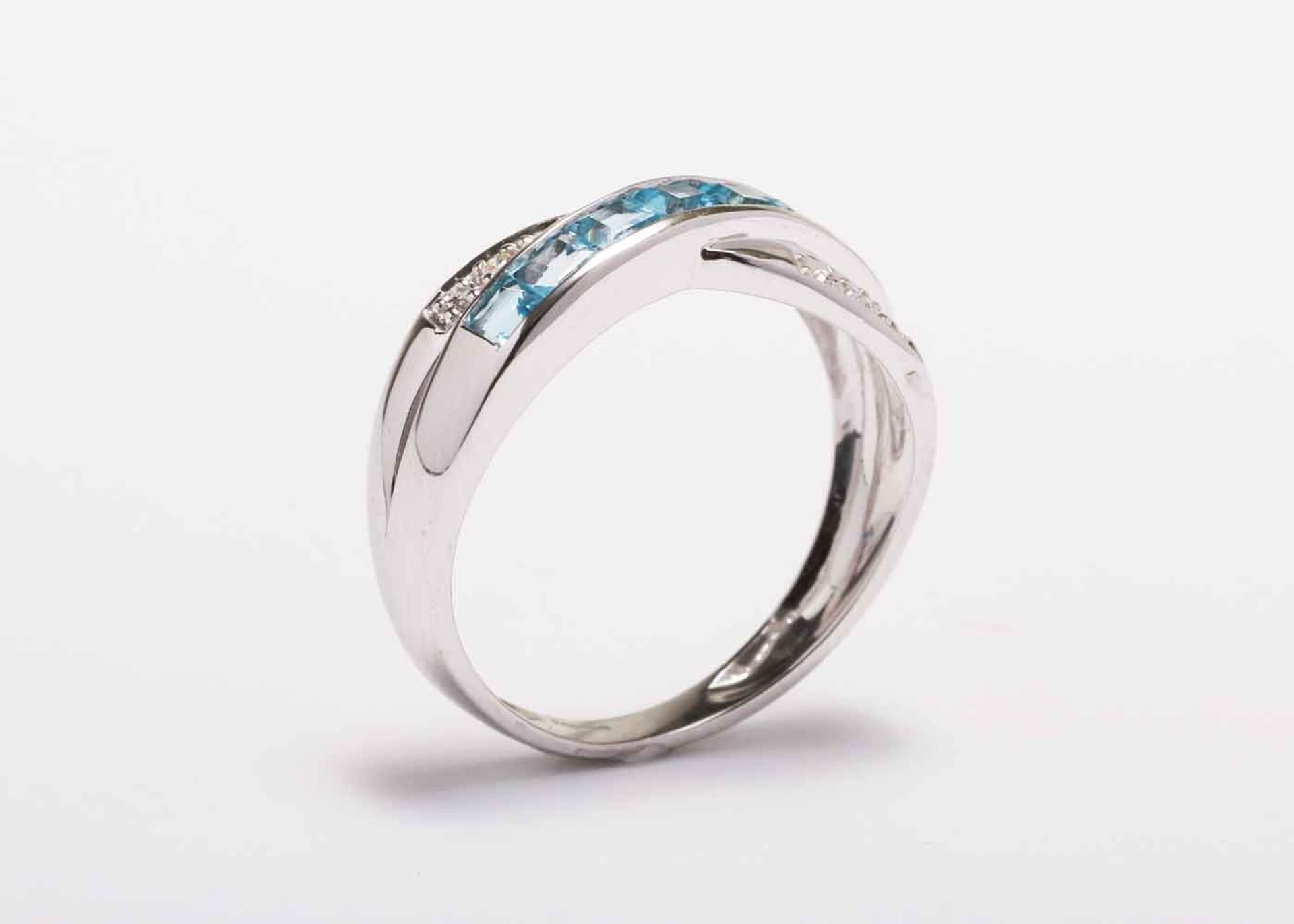 9ct White Gold Blue Topaz And Diamond Ring 0.06 Carats - Valued by GIE £1,625.00 - This twist on a - Image 8 of 9