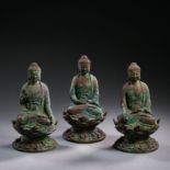 THREE SEATED BRONZE BUDDHAS, LIAO OR JIN DYNASTY, CHINA