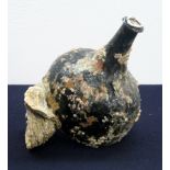 An extremely rare Black Glass 'Onion' bottle with deep punt in salvaged condition, encrusted with