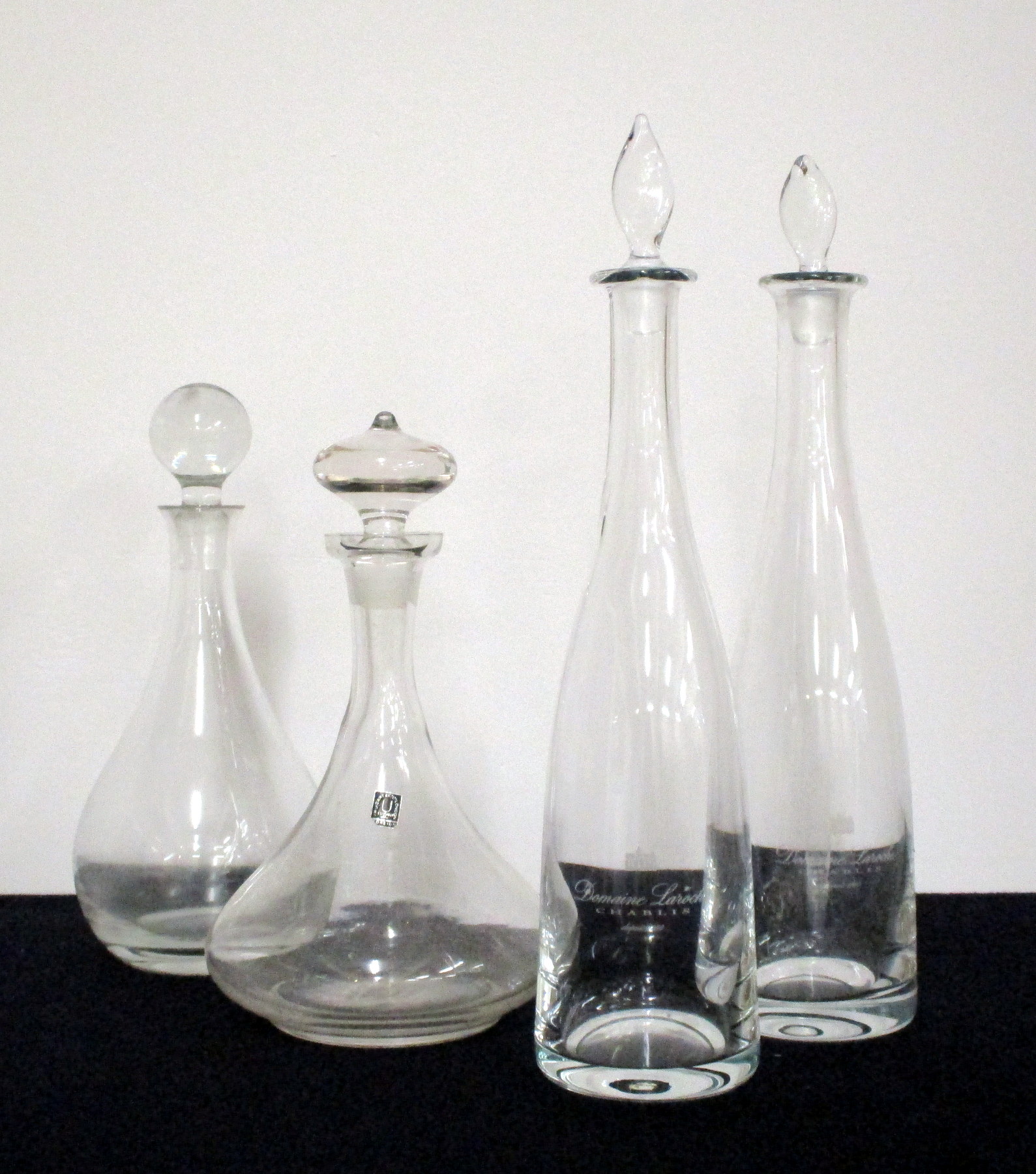 4 Assorted Decanters with stoppers including A Hand Blown Dom. Laroche Carafe