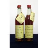 2 70-cl bts De La Motte Fine Petite Champagne Cognac 1914 bottle numbers 00067 and 00069, chipped