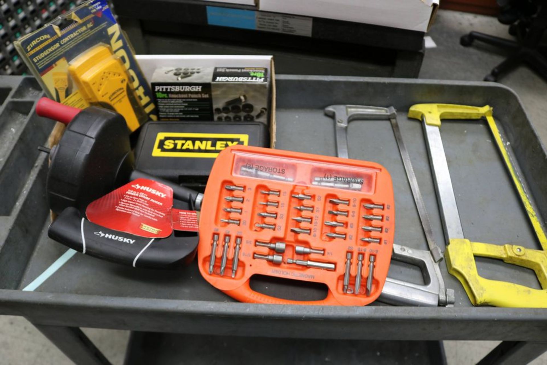 (2) Hack Saws, Zircon Stud Sensor Stud Finder, 10 Piece Knockout Punch Set, Stanley Drill Set, and