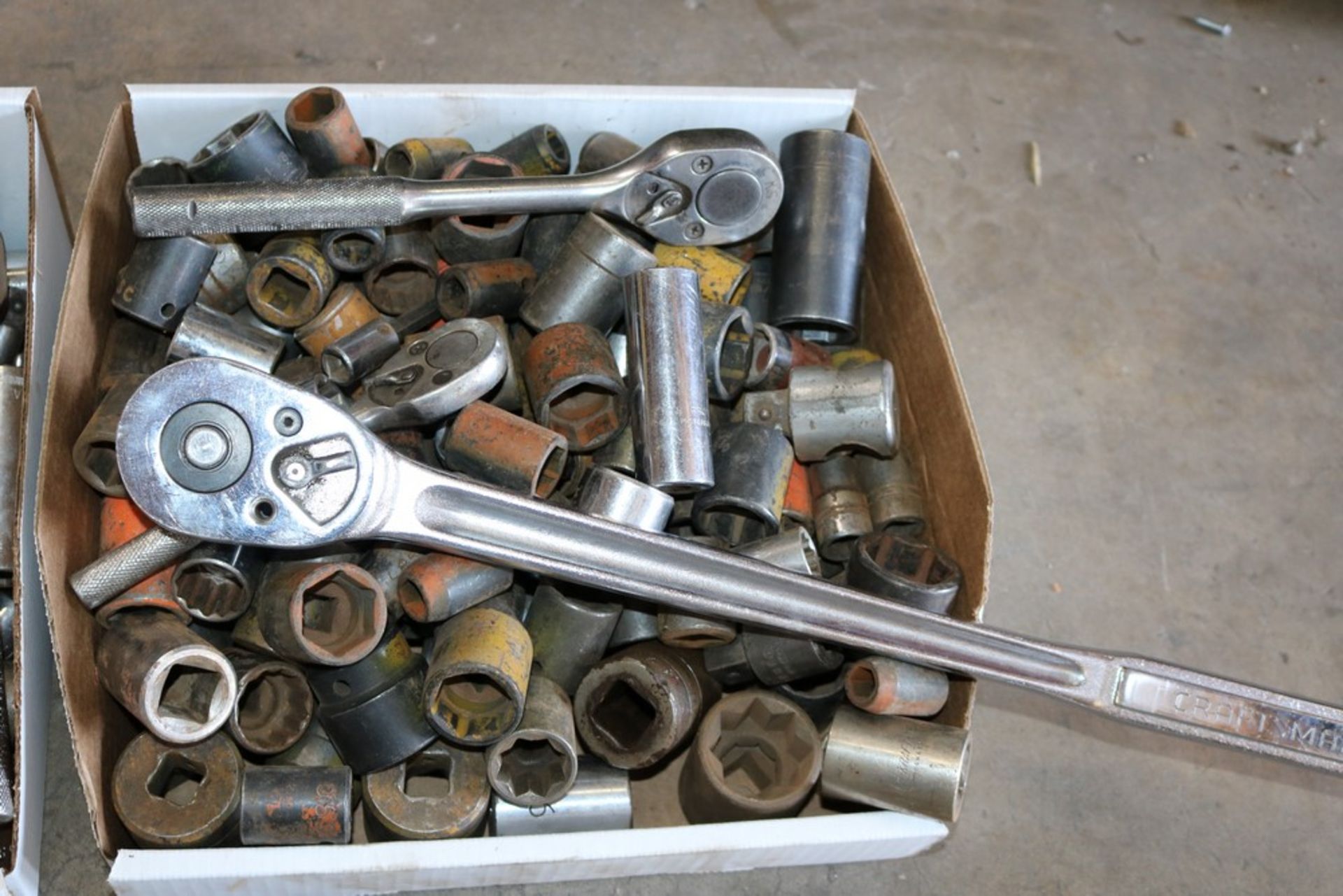 Box of various size sockets and socket wrenches