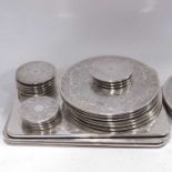 A collection of silvered table mats, including coa