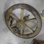 An iron banded wooden wheelbarrow wheel