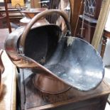 A copper coal scuttle