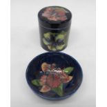 A Moorcroft jar and cover, clematis on blue patter