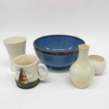 A Moorcroft cream glazed bowl, a vase, a bottle ne