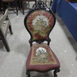 A Victorian ebonised and upholstered chair