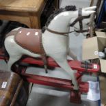 A Collingwood style carved wooden rocking horse