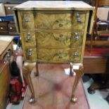 A walnut veneered drop flap chest of drawers, with