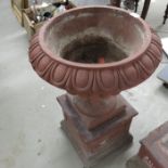 A pair of terracotta garden urns, campana form on