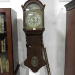 An oak wall hanging bracket clock