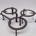 A wrought iron open fire tripod stand, and two oth